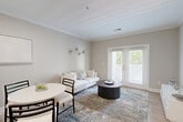 Located at 170 Market St in Manassas Park, VA, this thoughtfully designed one-bedroom, one-bathroom residence offers efficient single-floor living with a bright, open-concept layout. Light wood-tone flooring flows throughout, complemented by neutral warm-gray walls and crisp white trim that create a clean, cohesive aesthetic.

The kitchen is equipped with stainless steel appliances, white cabinetry, and a white quartz peninsula with an undermount sink that seamlessly connects to the dining area and living room — ideal for everyday functionality and entertaining. The open living and dining area is bathed in natural light from French doors that lead out to a private patio, offering a peaceful outdoor retreat.

The bedroom provides a comfortable, well-proportioned retreat with a generous window that brings in natural light. It features direct access to a walk-in closet and is conveniently connected to the full bathroom, which includes a white vanity with ample cabinet storage and a well-lit mirror. An additional closet and in-unit laundry room add practical storage and convenience. Crown molding in the living areas lends an elevated architectural touch, rounding out a space that balances style with everyday functionality.
