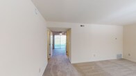 Located at 300 Cardinal Dr in Cincinnati, Ohio, this two-floor residence offers a practical and comfortable layout throughout its multiple levels. The living areas are finished with neutral-toned carpet flooring, creating a consistent and cohesive feel across the rooms. Natural light filters through several windows fitted with blinds, brightening the generously sized bedrooms, each of which includes closet storage. A ceiling fan is present in one of the main living areas, complementing the home's ventilation system.

The kitchen is equipped with stained granite-look countertops, light maple cabinetry providing ample storage, stainless steel appliances including an electric range and an over-the-range microwave. The laundry area features overhead cabinetry, washer and dryer hookups, and a dryer vent, along with hardwood-style flooring that also carries into utility sections of the home. A dedicated mechanical area houses the furnace and electrical panel, ensuring essential systems are centrally accessible.

A sliding glass door leads to an outdoor area, allowing natural light to flow into the interior corridor. The overall design is clean and neutral, offering a blank canvas suitable for a variety of living arrangements. The home's straightforward floor plan and well-distributed spaces make it a highly functional residence in a Cincinnati suburban setting.