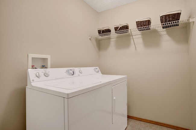 In unit laundry with shelving - Wellington Manor