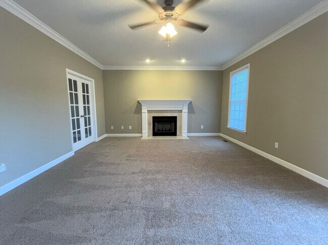 Family room with wood-burning fireplace! - 1802 Raven Hill Ct