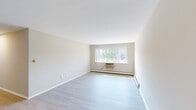 Located at 5110 Biscayne Ave in Racine, Wisconsin, this 2-bedroom, 1-bathroom single-floor residence features a clean, neutral palette throughout. The open combined living and dining area is bright and airy, with light hardwood-style flooring, white walls, and a large picture window that fills the space with natural light and offers outdoor views. A wall-mounted air conditioning unit and baseboard heating provide year-round climate control.

The kitchen is efficiently designed, featuring white cabinetry, marble-look countertops, and stainless steel appliances including a full-size refrigerator and dishwasher. Both bedrooms are carpeted and well-proportioned, each offering natural light through dedicated windows and access to closet space. The primary bedroom is generously sized and includes a walk-in closet area. With four closets total throughout the unit, storage is plentiful.

The full bathroom is neatly finished with a white vanity, ample counter space, a large mirror with overhead lighting, and a tub-shower combination. Light wood-tone flooring completes the clean, cohesive look. A central hallway connects all rooms, contributing to the practical and intuitive flow of this well-maintained residence.