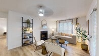 Located at 8000 Waters Ave in Savannah, GA, this single-story, 2-bedroom, 1-bathroom home offers a thoughtfully designed layout with a cohesive neutral aesthetic throughout. The living room serves as the heart of the home, showcasing light wood-style flooring, a wood-burning fireplace with a white mantle, and abundant natural light streaming through large windows dressed with blinds and curtains. A ceiling fan and access to an outdoor patio add comfort and functionality to the space. The kitchen features white cabinetry with modern black hardware, a stainless steel sink, and full appliances including a range and refrigerator, all set on the same warm wood-style flooring. The spacious primary bedroom offers plush carpeting, a large window, and generous proportions, while the second bedroom mirrors the cozy feel with carpet flooring and bright window access. A walk-in closet with built-in shelving provides ample storage. The bathroom includes a full tub-shower combination with dark fixtures and wood-style flooring. A dedicated laundry room accommodates a full-size washer and dryer. The home's warm, neutral palette and consistent finishes create a welcoming and cohesive living environment throughout.