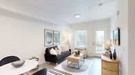 This thoughtfully designed single-floor residence offers a clean, contemporary aesthetic throughout, characterized by crisp white walls, light wood-look flooring, and an abundance of natural light. The open-concept living and dining area is welcoming and functional, anchored by a large window and a glass-paned door that leads to a private balcony with greenery views beyond. The kitchen is well-appointed with taupe shaker-style cabinetry, stainless steel appliances including a range, microwave, and refrigerator, white quartz countertops, and a subway tile backsplash. A peninsula with bar seating provides a practical and social dining option. The bedroom is a calm retreat featuring plush carpeting, a generous sliding-door closet, and a window that invites natural light and outdoor views. Soft neutral tones and quality finishes lend the room a restful ambiance. A dedicated in-unit laundry closet, fitted with a full-size washer and dryer and discreetly tucked behind louvered bifold doors, adds everyday convenience. The overall design balances modern simplicity with warm, natural textures, creating a cohesive and comfortable living environment throughout.