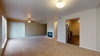 Located at 1400 N Pierce Street in Little Rock, Arkansas, this single-floor unit offers a well-designed layout with a variety of functional living spaces. The open-concept living and dining area is a standout feature, highlighted by plush carpeting, a ceiling fan, and a classic fireplace framed by built-in shelving — ideal for both everyday living and entertaining. Adjacent to the living space, the galley-style kitchen is efficiently organized with white cabinetry, granite-style countertops, a stainless steel refrigerator, electric range, microwave, and dishwasher, all complemented by rich dark wood-style flooring and track lighting overhead.

The bedrooms are generously proportioned, each featuring ceiling fans, soft carpeting, and ample closet space. The primary bedroom includes a private en-suite bathroom and walk-in closet access. Bathrooms throughout the unit are finished with white cabinetry, granite-style countertops, and dark hardwood-style flooring. One bathroom features a full tub-shower combination with clean white surround. Additional rooms with dark hardwood-style flooring provide versatile space that could serve as a home office or additional bedroom, rounding out a thoughtfully appointed and move-in ready unit.