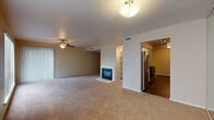 Located at 1400 N Pierce Street in Little Rock, Arkansas, this single-floor unit offers a well-designed layout with a variety of functional living spaces. The open-concept living and dining area is a standout feature, highlighted by plush carpeting, a ceiling fan, and a classic fireplace framed by built-in shelving — ideal for both everyday living and entertaining. Adjacent to the living space, the galley-style kitchen is efficiently organized with white cabinetry, granite-style countertops, a stainless steel refrigerator, electric range, microwave, and dishwasher, all complemented by rich dark wood-style flooring and track lighting overhead.

The bedrooms are generously proportioned, each featuring ceiling fans, soft carpeting, and ample closet space. The primary bedroom includes a private en-suite bathroom and walk-in closet access. Bathrooms throughout the unit are finished with white cabinetry, granite-style countertops, and dark hardwood-style flooring. One bathroom features a full tub-shower combination with clean white surround. Additional rooms with dark hardwood-style flooring provide versatile space that could serve as a home office or additional bedroom, rounding out a thoughtfully appointed and move-in ready unit.