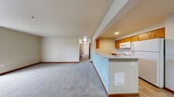 Located at 2129 Maltby Rd in Bothell, WA, this 2-bedroom, 3-bathroom single-floor residence offers a well-organized and functional layout. The open-concept kitchen and living area serves as the heart of the home, featuring wood-look flooring, a peninsula countertop with light-colored surfaces, warm wood cabinetry, and white appliances including a refrigerator, range, and microwave. A vaulted ceiling accent adds a sense of height and openness to this shared space.

The living room extends comfortably from the kitchen, transitioning to plush carpeting that continues into both bedrooms. The primary bedroom is a generously sized retreat, offering a sliding door that invites natural light, while the second bedroom features a window with outdoor views of the surrounding greenery. Both bedrooms include warm wood-toned sliding closet doors for convenient storage.

A hallway connects the private areas of the home, leading to the three bathrooms. Each bathroom is finished with wood-look flooring, light countertops, warm wood cabinetry, and well-lit vanity mirrors. At least one bathroom includes a full tub-shower combination. Rich wood baseboards and trim provide consistent, warm detailing throughout the entire residence, contributing to a cohesive and inviting overall ambiance.