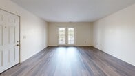 Located at 1300 Hazel Ln in Farmington, Missouri, this single-floor, three-bedroom, two-bathroom home offers a practical and comfortable layout with consistent wood-look flooring carried throughout every room. The living area is open and bright, anchored by a set of French doors that welcome natural light and provide outdoor access, creating an airy, welcoming atmosphere. The kitchen is well-appointed with light wood cabinetry, dark countertops, ample upper and lower storage, and included appliances — a refrigerator, electric range, and dishwasher — all set atop durable wood-look flooring. The primary bedroom provides a comfortable retreat with its own generous footprint, while two additional bedrooms offer clean, neutral spaces with easy-care flooring. Both bathrooms are finished with wood-look vinyl flooring, vanities with dark countertops, and tub-shower combinations. One bathroom features warm yellow-toned cabinetry, while the second offers a longer vanity layout with a full mirror. Closet storage is present throughout, including a set of double doors near the kitchen entry. Clean white walls and panel-style interior doors give the home a cohesive, well-maintained appearance throughout.