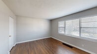 Located at 1015 W 41st Pl in Kansas City, Missouri, this single-floor, 3-bedroom, 1-bathroom home offers a straightforward and functional layout. Rich hardwood flooring runs throughout the living areas and bedrooms, providing a warm and cohesive look across the space.

The generously sized primary bedroom benefits from large windows fitted with blinds, allowing for ample natural light while maintaining privacy. It features sliding mirrored closet doors, offering practical storage solutions. The two additional bedrooms are well-proportioned, each with hardwood floors and windows that bring in natural light.

The kitchen is laid out in a galley style, featuring warm-toned wooden cabinetry, a tile backsplash, light countertops, and black appliances including a gas range. A window above the sink provides natural light, and a door offers convenient exterior access.

The bathroom is clean and efficiently designed, with white subway tile surrounding the tub-shower combo, a vanity with under-cabinet storage, a mirrored medicine cabinet, and updated fixtures. A hallway connects the rooms, providing a logical flow throughout the home.

The neutral gray walls and consistent flooring throughout create a cohesive and move-in-ready atmosphere, making this a practical and comfortable home.