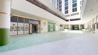 Located in the heart of Miami's vibrant Wynwood Arts District, this large-scale ground-floor commercial shell space presents a rare opportunity for a distinctive retail, creative, or mixed-use tenant. The property spans a substantial single floor, offering an expansive, open footprint divided into six versatile sections that can accommodate a wide range of layouts and configurations.

The space is currently in shell condition, featuring exposed concrete masonry walls, raw concrete and compacted earth flooring, and visible overhead infrastructure including red fire suppression piping and conduit — all hallmarks of an industrial aesthetic that suits Wynwood's creative character. Soaring ceiling heights allow for dramatic interior design possibilities, and multiple street-facing windows and glass-paneled entry doors invite abundant natural light throughout.

A notably finished common area features polished concrete flooring with a distinctive green hue, painted columns, recessed accent lighting, and integrated planters — providing a refined preview of the building's design quality. Large roll-up doors offer flexible access, while glazed storefronts face directly onto NW 1st Avenue. Outside, palm-lined sidewalks and colorful neighborhood murals frame the building within one of Miami's most culturally dynamic and high-traffic corridors.