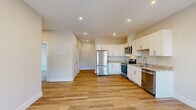 Located at 16 Sullivan St in Berwick, Maine, this single-floor, 2-bedroom, 1-bathroom residence offers a clean, modern design with thoughtful finishes throughout. The kitchen serves as a functional centerpiece, featuring crisp white shaker-style cabinetry, granite countertops, light hardwood-style flooring, and a full suite of stainless steel appliances including a refrigerator, electric range, over-the-range microwave, and dishwasher. Recessed lighting brightens the space, creating a fresh and inviting atmosphere. The full bathroom continues the home's contemporary aesthetic with a white vanity topped with granite countertops, brushed nickel fixtures, hardwood-style flooring, and a full tub-shower combination. Both bedrooms are finished with neutral-toned carpet and feature windows with roller shades that allow for natural light and outdoor views. The spacious primary bedroom includes a bay-style window arrangement and a double-door closet, providing ample storage. The second bedroom is well-proportioned with its own window. A dedicated closet adds additional storage convenience. Neutral wall tones and consistent finishes throughout lend the home a cohesive, move-in-ready feel.