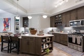 Located in the desirable Sandy Springs neighborhood of Atlanta, this thoughtfully designed single-floor residence offers a cohesive blend of contemporary style and functional living. The open-concept living area is anchored by light hardwood flooring, a striking drum pendant light fixture, and an abundance of natural light streaming through large windows with access to an outdoor area. Neutral tones and carefully curated décor create a welcoming ambiance throughout.

The kitchen is a standout feature, showcasing rich dark espresso cabinetry reaching to the ceiling, a subway tile backsplash, stainless steel appliances including a French door refrigerator and gas range, quartz countertops, and a central island ideal for both prep work and casual dining.

Multiple bedrooms provide comfortable retreats, each featuring plush carpeting, generous natural light from well-positioned windows, and ample space for varied furnishing arrangements. The rooms carry a calm, sophisticated palette of soft grays and warm neutrals.

The bathrooms are finished with tile surround, dark vanity cabinetry, and clean white countertops. One bath features a soaking tub with shower combination, while another offers a glass-enclosed shower and a spacious double vanity, providing both comfort and practicality for daily living.