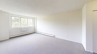 Located at 352 Newfield St in Middletown, Connecticut, this three-bedroom, one-bathroom unit offers a practical and well-organized single-floor layout. The spacious primary bedroom features large windows that invite natural light and offer views of surrounding greenery, complemented by soft carpeting and baseboard heating throughout. The additional bedrooms are similarly carpeted and bright, each equipped with generous closet space, including built-in folding-door closets, and windows fitted with blinds for privacy. A hallway connects the rooms efficiently, with a dedicated closet providing extra storage. The kitchen is outfitted with warm honey-toned wood cabinetry, granite-patterned countertops, a stainless steel sink, a gas range, and a full-size refrigerator, all set on easy-care tile flooring. The bathroom features a full tub-shower combination with white tile surround and accessible grab bars for added safety and convenience. Baseboard heating is present throughout the unit, ensuring consistent warmth. The clean, neutral palette of white walls and light carpeting creates a bright, cohesive atmosphere across the entire space, making it a straightforward and functional home.