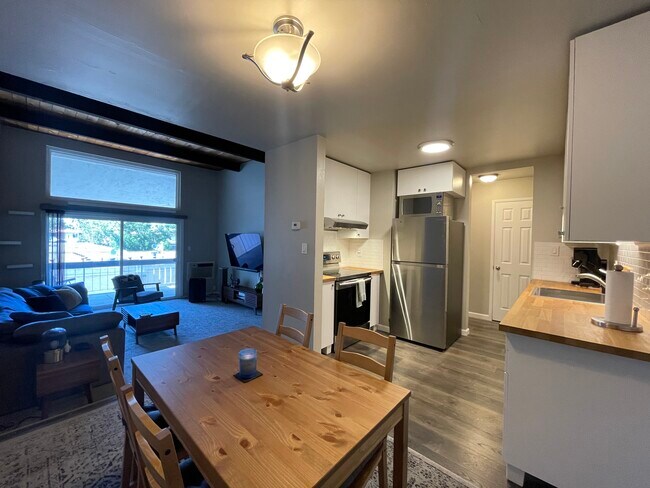The full kitchen and dining area flow seamlessly into the living room. - 1591 Ellis St