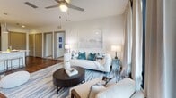 Located at 6207 S West Shore Blvd in Tampa, FL, this well-appointed single-floor residence showcases a contemporary design with clean lines, neutral tones, and thoughtfully curated finishes throughout. The open-concept living area features rich hardwood-style flooring, a ceiling fan, and large windows with floor-to-ceiling drapes that invite natural light into the space. The kitchen is a standout, equipped with stainless steel appliances, a dual-tone cabinet design pairing white uppers with warm wood lowers, a subway tile backsplash, quartz countertops, and a breakfast bar with seating — ideal for both casual dining and entertaining. The bedrooms offer comfortable carpeted flooring, ceiling fans, and generous walk-in closets with built-in shelving systems. One bedroom features a large sliding glass door providing direct outdoor views and access. The primary bathroom includes large-format tile flooring, a glass-enclosed walk-in shower, and direct access to a well-organized walk-in closet. A second full bathroom offers a soaking tub with shower, a white vanity with quartz countertop, and an illuminated mirror. Throughout the residence, the design maintains a cohesive, modern coastal aesthetic, making it a comfortable and stylish home in the South Tampa area.