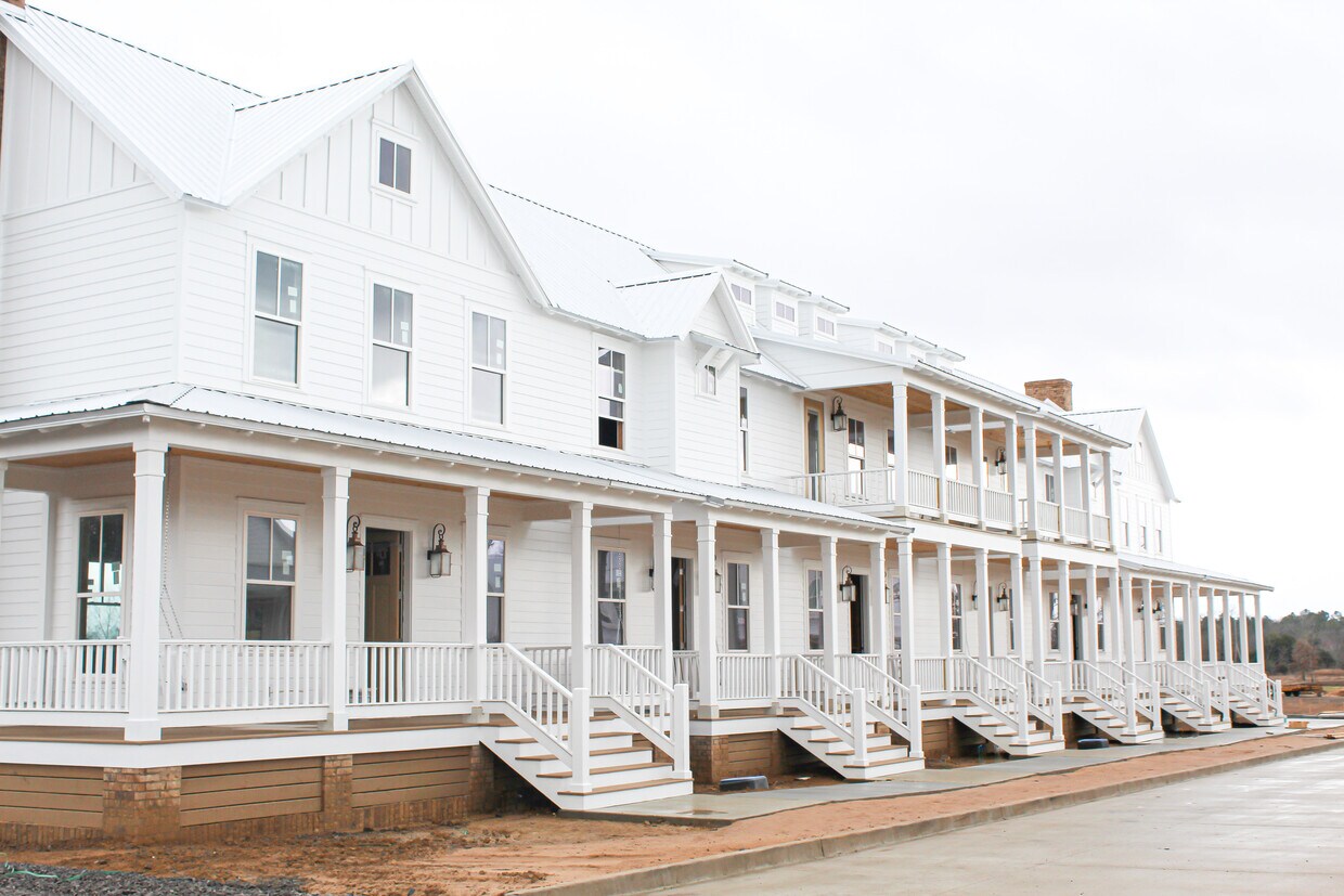 Townhome is on the far right end with the larger porch and faux chimney! - 2100 Loretta Parker Ln