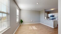 Located at 5730 Silver Falls St in Dublin, OH, this well-designed 2-bedroom, 2-bathroom single-floor home offers a thoughtful layout with clean, neutral finishes throughout. The open living room is bathed in natural light from multiple windows fitted with horizontal blinds, showcasing light hardwood-style flooring and soft gray walls that create a bright, airy atmosphere with views of the surrounding neighborhood.

The kitchen is a functional highlight, featuring crisp white cabinetry, light countertops, a classic subway tile backsplash, and stainless steel appliances including a range, microwave, and refrigerator. A window above the sink adds additional natural light to the space.

Both bedrooms are carpeted for comfort and include dedicated closets with built-in shelving and hanging rods. The primary bedroom offers a generous footprint with a large closet, while the second bedroom is equally well-appointed with its own window and recessed lighting.

The two bathrooms are finished in a consistent neutral palette with white vanities and light flooring. One bathroom includes a full soaking tub and shower combination, while the second features a clean, efficient layout with a vanity and toilet. Two closets provide ample storage throughout the home, rounding out this practical and inviting residence.