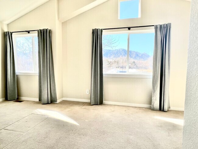 Two windows in the primary bedroom have a beautiful view of the Flatirons. - 623 Tantra Dr
