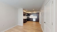 Located at 2281 E 89th St in Cleveland, OH, this single-floor, one-bedroom, one-bathroom unit offers a thoughtfully designed layout that maximizes every square foot. The open-concept kitchen and living area serves as the heart of the space, featuring rich dark espresso cabinetry that extends floor to ceiling, light-toned countertops, a subway tile backsplash, and stainless steel appliances including a dishwasher and over-the-range microwave. A peninsula adds additional counter space and storage, while recessed lighting keeps the area bright and welcoming. Light hardwood flooring runs throughout the main living areas, lending warmth and visual continuity. The bedroom is a comfortable, well-proportioned retreat with neutral walls, hardwood flooring, natural light from a window, and a double-door closet offering ample storage. The bathroom is clean and functional, featuring a tiled tub-shower combination, tile flooring in warm beige tones, and chrome fixtures. Additional conveniences include a dedicated laundry area, a utility room, and a closet for extra storage. The overall aesthetic is modern and understated, with a neutral color palette and clean finishes that create a calm, move-in-ready environment.