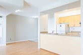 Located at 171 Main St N in Brampton, Ontario, this two-bedroom, one-bathroom unit offers a well-organized single-floor layout designed for comfortable everyday living. The open-concept living and dining area is finished with warm hardwood-style flooring and neutral grey walls, creating a bright and inviting atmosphere. Large windows flood the space with natural light, while a sliding glass door opens onto a private balcony that offers elevated views of the surrounding Brampton cityscape. The kitchen is positioned adjacent to the living area and features light wood cabinetry, laminate countertops, a double sink, and a white electric range with an overhead exhaust fan. Tile flooring in the kitchen provides a practical transition from the main living space. Both bedrooms continue the hardwood-style flooring and neutral tones, offering clean, versatile spaces. The primary bedroom benefits from a large window with city views, while the second bedroom provides a quiet, enclosed retreat. The bathroom is finished with tile flooring and features a combined tub and shower, a toilet, and a vanity with under-sink storage and warm-toned countertop. The overall design is clean, functional, and well-suited for urban living in central Brampton.