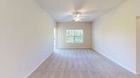 Located at 9001 Mason Village Loop in Manassas, VA, this well-appointed 2-bedroom, 3-bathroom residence offers a thoughtfully designed single-floor layout. The kitchen is a functional centerpiece, featuring rich wood cabinetry, granite countertops, stainless steel appliances including a refrigerator, microwave, and range, and wood-style flooring. A peninsula with an integrated sink and granite surface opens toward the entryway, enhancing the sense of openness. The living area is carpeted and bathed in natural light, with a ceiling fan overhead and direct access to a private balcony overlooking a lush, wooded landscape. Both bedrooms are carpeted and generously sized, with the primary bedroom offering ample room and natural light through large windows. The bathrooms echo the kitchen's design with wood cabinetry and granite-topped vanities, complemented by wood-style flooring. A dedicated laundry and utility area with stacked washer/dryer hookups and a water heater adds everyday convenience. Neutral, warm-toned walls throughout create a clean and welcoming ambiance, making this Manassas residence a comfortable and practical place to call home.