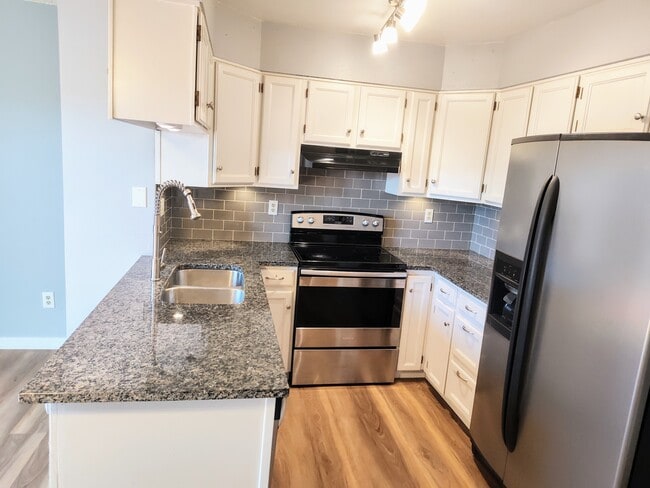 Updated kitchen with stainless steel appliances. - 10856 Bayfield Way