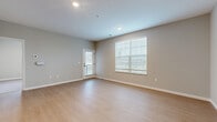 Located at 7181 N Hamilton Rd in Columbus, Ohio, this well-designed one-bedroom, one-bathroom unit offers a functional and modern layout across a single floor. The open-concept living and kitchen area forms the heart of the home, featuring light-toned luxury vinyl plank flooring, neutral warm-gray walls, and recessed lighting throughout. The kitchen is equipped with stainless steel appliances — including a refrigerator, range, and microwave — complemented by gray shaker-style cabinetry and a spacious granite-topped island with an undermount sink, ideal for both cooking and casual dining. The living area benefits from a private exterior door and a large window fitted with blinds, allowing ample natural light. The bedroom is carpeted for comfort and is brightened by two windows offering outdoor views of the surrounding community. It includes access to a walk-in closet with wire shelving for organized storage. An additional closet provides further storage flexibility. The bathroom features a gray vanity with a granite countertop, an undermount sink with a modern faucet, and a well-lit mirror. A dedicated laundry area adds everyday convenience. The unit presents a clean, contemporary aesthetic with consistent finishes throughout.