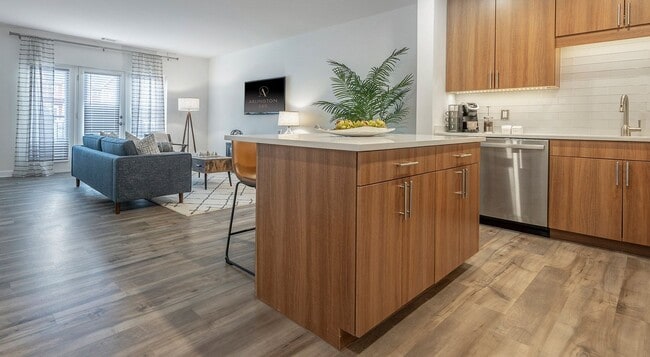 The island does double duty as prep space and the divider between rooms. - Arlington 360