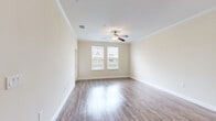 Located at 10000 Davis Creek Circle in Orlando, FL, this well-appointed 1-bedroom, 1-bathroom residence offers a thoughtfully designed single-floor layout. The open-concept living, dining, and kitchen area serves as the heart of the home, featuring rich hardwood-style flooring, crown molding, and a ceiling fan that keeps the space bright and comfortable. Large windows invite generous natural light throughout.

The kitchen is a standout, showcasing dark espresso cabinetry, granite countertops, a peninsula with pendant lighting, and a full suite of stainless steel appliances including a refrigerator, range, microwave, and dishwasher. An arched entryway adds architectural character as it transitions into the hallway.

The bedroom is a comfortable retreat with plush carpeting, a ceiling fan, and dual windows offering pleasant outdoor views. The full bathroom features a dark vanity with granite countertops, a large mirror, and a shower-tub combo. A dedicated in-unit laundry room with side-by-side washer and dryer adds everyday convenience. Additional storage is provided via a hallway closet. A private patio rounds out this functional and attractive residence.