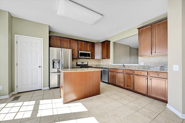 Upgraded kitchen with island and new stainless steel appliances - 307 Ellison Dr