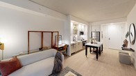 Located at 2 I St NE in Washington, DC, this contemporary apartment on the second floor offers a thoughtfully designed single-level layout that blends modern aesthetics with functional living. The open-concept floor plan seamlessly connects the kitchen, dining, and living areas, creating a bright and cohesive space throughout.

The kitchen is a standout feature, outfitted with sleek white upper cabinetry, light wood lower cabinets, quartz countertops, and a striking marble-style backsplash. Stainless steel appliances — including a range, over-the-range microwave, dishwasher, and refrigerator — complete the well-appointed space, which also benefits from recessed lighting.

The living area is anchored by large floor-to-ceiling sliding glass doors that open to an outdoor-facing view, flooding the room with natural light. Light wood-style flooring runs throughout the main living spaces, enhancing the airy, modern feel.

The bedroom is generously proportioned, featuring clean white walls, dual closets, and a calm, restful atmosphere. The bathroom continues the contemporary design language with a wood-toned vanity, white quartz countertop, backlit mirror, and black hardware accents. Light-toned flooring ties the space together with a clean, minimal finish.