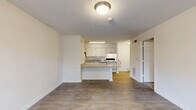 This 560-square-foot apartment in Atlanta offers a practical and efficient living space. The single-story layout comprises two bedrooms, one bathroom, and an open-concept kitchen and living area. The primary bedroom is generously sized at 170 square feet, providing ample space for comfort.

The kitchen is modern and functional, featuring white cabinetry, a full-size refrigerator, and essential appliances including a dishwasher and electric range. The light-colored countertops complement the overall bright aesthetic of the space. Adjacent to the kitchen, the living room boasts a large window that allows natural light to flood the area, creating an open and airy atmosphere.

Both bedrooms feature neutral-toned carpeting and are equipped with closet space. The bathroom, while compact, is efficiently designed with a pedestal sink, toilet, and shower/tub combination. The wood-look vinyl flooring in the main living areas and bathroom adds warmth and durability to the space.

Throughout the apartment, white walls and ceilings contribute to a clean, fresh appearance, while recessed lighting and ceiling fixtures provide ample illumination. The overall design prioritizes functionality and maximizes the use of available space, making it an ideal option for those seeking a cozy yet practical urban dwelling in Atlanta.