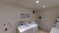 This single-floor laundry facility offers a straightforward, utilitarian space designed to accommodate shared laundry needs efficiently. The room features a set of commercial-grade washing machines and dryers arranged along the walls, providing ample capacity for regular use. The machines are equipped with coin or card-operated controls, making them suitable for a multi-user environment.

The interior is finished with neutral, light-colored walls that contribute to a clean and bright atmosphere. Recessed ceiling lights provide consistent, even illumination throughout the space. The flooring is a light-toned, easy-to-maintain surface appropriate for a high-traffic utility area.

Instructional and informational posters are mounted on the wall above the machines, offering guidance on proper machine use. Additional utility fixtures, including what appears to be a mounted control panel or intercom unit and plumbing connections, are visible along the walls, underscoring the room's functional design.

Overall, the space is practical and well-organized, prioritizing ease of use and maintenance in a shared laundry setting.