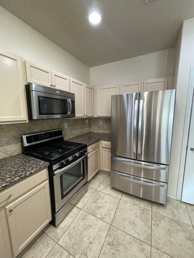 Kitchen with appliances - 11019 Marina Gate Trl NE