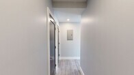 Located at 365 Western Ave in Boston's Brighton neighborhood, this thoughtfully designed 2-bedroom, 2-bathroom residence offers a clean, contemporary aesthetic throughout its well-appointed single floor. Light wood-style flooring flows consistently through every room, complementing a neutral gray-and-white color palette that creates a bright, cohesive atmosphere.

The open-concept kitchen and living area serves as the heart of the home, featuring gray shaker-style cabinetry, white subway tile backsplash, and a full suite of stainless steel appliances including a gas range, dishwasher, and refrigerator. Large black-framed windows invite ample natural light and frame views of the surrounding Boston cityscape.

Both bedrooms are comfortably proportioned, with the primary bedroom benefiting from a corner window configuration that maximizes natural light and views. The second bedroom also features a large black-framed window and a set of double closet doors for generous storage.

The two bathrooms are finished with upscale details: one features a tub/shower combination clad in large-format marble-style tile with a sliding glass door, while the second offers a gray vanity with a white countertop, geometric tile flooring in a herringbone pattern, and a sleek black-framed mirror. Clean hallways with recessed lighting connect all areas of the residence efficiently.