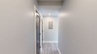 Located at 365 Western Ave in Boston's Brighton neighborhood, this thoughtfully designed 2-bedroom, 2-bathroom residence offers a clean, contemporary aesthetic throughout its well-appointed single floor. Light wood-style flooring flows consistently through every room, complementing a neutral gray-and-white color palette that creates a bright, cohesive atmosphere.

The open-concept kitchen and living area serves as the heart of the home, featuring gray shaker-style cabinetry, white subway tile backsplash, and a full suite of stainless steel appliances including a gas range, dishwasher, and refrigerator. Large black-framed windows invite ample natural light and frame views of the surrounding Boston cityscape.

Both bedrooms are comfortably proportioned, with the primary bedroom benefiting from a corner window configuration that maximizes natural light and views. The second bedroom also features a large black-framed window and a set of double closet doors for generous storage.

The two bathrooms are finished with upscale details: one features a tub/shower combination clad in large-format marble-style tile with a sliding glass door, while the second offers a gray vanity with a white countertop, geometric tile flooring in a herringbone pattern, and a sleek black-framed mirror. Clean hallways with recessed lighting connect all areas of the residence efficiently.
