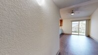 This 760 square foot apartment in Austin, Texas offers a well-designed living space with two bedrooms and two bathrooms. The primary bedroom, measuring 160 square feet, provides ample space for comfort. The modern kitchen boasts wooden cabinets, granite countertops, and stainless steel appliances, opening to a living area with wood-look flooring and large windows for natural light. Both bathrooms feature granite vanities and tiled walls, with one offering a shower/tub combination. The unit includes an in-unit laundry room with full-sized appliances. Ceiling fans in bedrooms and living areas provide additional comfort. Sliding closet doors in bedrooms maximize space efficiency. The apartment's open concept design creates a seamless flow between the kitchen and living area, ideal for entertaining. A balcony accessible from the living room offers outdoor space. The neutral color palette and modern finishes throughout create a contemporary and inviting atmosphere in this compact yet functional urban dwelling.