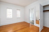 Located at 1226 29th St S in Birmingham, Alabama, this single-floor home showcases a classic design with warm hardwood flooring running throughout the living spaces. The layout, visible in the dollhouse overview, offers a well-connected series of rooms that flow naturally from one to the next.

The living area is a standout feature, highlighted by a charming bay window configuration with three windows that invite ample natural light, complemented by a ceiling fan overhead. The warm-toned hardwood floors and crisp white walls create a clean, inviting atmosphere throughout.

Multiple rooms provide versatile living space, each featuring the same hardwood flooring and white-painted walls. One room includes a built-in closet with a hanging rod, offering practical storage. Windows fitted with horizontal blinds are present in each room, providing both light control and privacy.

The kitchen is efficiently laid out, equipped with a gas range, refrigerator, and a single-basin sink set into a wood-toned countertop. Dark hardwood flooring distinguishes the kitchen area from the rest of the home.

The bathroom is finished in classic white tile, featuring a tub-shower combination, a toilet, and a window with blinds for ventilation. The hexagonal tile flooring adds a timeless detail to the space. Overall, this home presents a straightforward, functional layout with consistent finishes throughout.