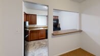 Located at 4608 Haverford Pl in Wilmington, Delaware, this single-floor, three-bedroom, one-bathroom residence offers a practical and comfortable layout. The living area features neutral-toned wall-to-wall carpeting, a window unit for climate control, and a baseboard heating system, creating a cozy atmosphere throughout. A pass-through counter connects the living space to the kitchen, which is equipped with warm wood cabinetry, granite-style countertops, a black appliance suite including a range, microwave, and refrigerator, and a mosaic tile backsplash accenting the cooking area. Tile flooring completes the kitchen's functional design. The spacious primary bedroom benefits from multiple windows that invite natural light and includes its own wall-mounted air conditioning unit. The two additional bedrooms are similarly carpeted and offer ample space, with one featuring a double-door closet. A hallway connects the bedrooms and leads to the full bathroom, which is a standout feature with its elegant marble-patterned surround encasing a full soaking tub and shower combination with polished chrome fixtures. A dedicated closet provides additional storage throughout this efficiently designed home.