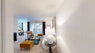 Located at 8732 Town and Country Boulevard in Ellicott City, MD, this well-appointed one-bedroom, one-bathroom residence offers a thoughtfully designed single-level layout. The bright living room features plush carpeting, clean white walls, and a sliding glass door that opens to a private balcony, flooding the space with natural light and providing pleasant outdoor views. Adjacent to the living area, a dedicated dining room boasts light hardwood-style flooring and a window overlooking the surroundings, creating an inviting space for meals. The kitchen is outfitted with white cabinetry with matte black hardware, marble-look countertops, stainless steel appliances including a gas range and refrigerator, and a sleek black faucet — combining style with functionality. The generously sized bedroom offers carpeted floors, a large window with natural light, and access to a walk-in closet with full wire shelving. Two additional closets throughout the unit provide exceptional storage. The bathroom features a clean white palette with a tub-shower combination, wood-style flooring, and a white vanity with black accents. An entrance foyer completes the layout, offering a welcoming arrival experience.