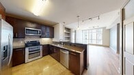 This contemporary 1-bedroom, 1-bathroom apartment offers an impressive 660 square feet of living space in the heart of San Diego. The unit boasts floor-to-ceiling windows that flood the space with natural light and provide breathtaking views of the city skyline. The open-concept layout seamlessly integrates the living room, dining area, and kitchen, creating a spacious feel perfect for both relaxation and entertainment.

The kitchen is a chef's dream, featuring sleek dark wood cabinetry, stainless steel appliances, and granite countertops. The bathroom continues the modern aesthetic with a large vanity, ample storage, and high-quality fixtures. The bedroom, measuring 140 square feet, offers a generous space for rest and includes a closet for storage.

Throughout the apartment, you'll find a mix of plush carpeting in the bedroom and living areas, with durable tile flooring in the kitchen and bathroom. The unit also includes a convenient in-unit washer and dryer. The building's prime location at 969 Market St puts residents in the center of San Diego's vibrant downtown, offering easy access to restaurants, shopping, and entertainment options.