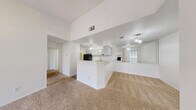 This single-floor, 2-bedroom, 1-bathroom home in Austin, Texas offers a practical and comfortable layout across a well-utilized footprint. The open-concept living and kitchen area serves as the heart of the home, featuring a brick-surround wood-burning fireplace and a sliding glass door that fills the space with natural light and provides outdoor access. Carpet throughout the living areas adds warmth underfoot, while the entry features hard flooring at the threshold.

The kitchen is equipped with gray upper cabinetry, white lower cabinets, light countertops, a double-basin stainless steel sink, a black electric range, a dishwasher, and wood-look vinyl flooring — providing a clean, functional workspace.

Both bedrooms are carpeted and include ceiling fans with light fixtures. The primary bedroom is a comfortable size and benefits from natural light through a window with blinds. The second bedroom also features a ceiling fan and vertical blinds. A dedicated closet and hallway round out the floor plan.

The full bathroom offers a tub/shower combo with tile surround, a large vanity with under-sink storage, a wide mirror with overhead lighting, and wood-look vinyl flooring. The textured ceilings are consistent throughout the home, adding a classic touch to this well-laid-out Austin residence.