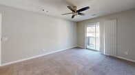Located at 1700 Hunter Ridge Ln in Peachtree Corners, GA, this one-bedroom, one-bathroom residence offers a practical and well-organized single-floor layout. The combined living and dining area forms the heart of the home, featuring plush carpeting, a ceiling fan with light fixture, a textured ceiling, and a sliding glass door that opens onto a private balcony, filling the space with natural light. The galley-style kitchen is efficiently arranged with white cabinetry, light countertops, black appliances including a refrigerator and range, wood-look flooring, and a window that brings in additional daylight. The bedroom is a comfortable, well-proportioned room with carpet flooring, a ceiling fan, a natural light window, and a closet with panel doors. Multiple closets throughout the unit provide generous storage options. The bathroom is clean and functional, featuring a full tub/shower combo with built-in shelving and a crisp white surround. A dedicated utility room adds further practicality to this thoughtfully arranged home. The neutral color palette throughout creates a bright, move-in-ready atmosphere suited for a range of lifestyles.