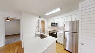 Located at 400 W 123rd Ave in Westminster, Colorado, this one-bedroom, one-bathroom unit offers a well-designed single-floor layout with a thoughtful mix of style and functionality. The living room is bright and open, featuring light wood-style flooring, a ceiling fan, large windows with blinds, and a sliding glass door that invites natural light and provides outdoor access. The kitchen is a standout space, showcasing white shaker cabinetry, a classic subway tile backsplash, sparkling quartz countertops with an integrated sink, and a full suite of stainless steel appliances including a refrigerator, range, and over-the-range microwave. A walk-in pantry adds generous storage directly off the kitchen. The bedroom is carpeted and comfortably sized, with a large window offering views to the outdoors and a ceiling fan overhead. A dedicated closet provides additional storage. The bathroom features a full tub/shower combination clad in white subway tile, wood-style flooring, and clean white finishes. In-unit laundry is conveniently housed in its own dedicated space. Textured ceilings are consistent throughout, adding a classic residential feel to this well-appointed Westminster home.