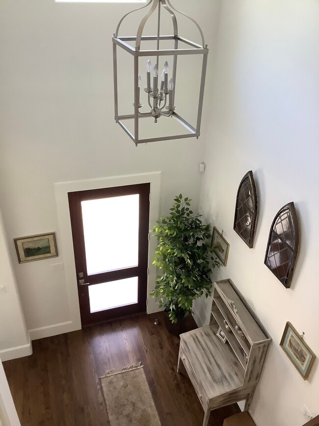 High ceilings, premium base boards & crown molding, beautiful wood floors greet you upon entry - 609 Aqua Dr
