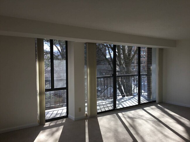 Living Room with ceiling to floor windows and sliding door to big private balcony - 1401 N Rhodes St