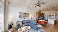 Located at Town Center Blvd in El Dorado Hills, CA, this thoughtfully designed one-bedroom, one-bathroom residence offers a modern aesthetic across a single floor. The open-concept living and dining area is bathed in natural light from large windows, with light wood-style flooring, clean white walls, and a ceiling fan that enhance the bright, airy atmosphere. The kitchen is well-appointed with rich wood-toned cabinetry extending to the ceiling, stainless steel appliances including a side-by-side refrigerator and electric range, a subway tile backsplash, and a sleek island with pendant lighting — ideal for both cooking and casual dining. The living area flows seamlessly from the kitchen, offering generous space for relaxing and entertaining. The bedroom is a comfortable retreat featuring plush carpeting, large windows with outdoor views, a ceiling fan, and recessed lighting. A dedicated walk-in closet provides ample built-in shelving and hanging space. The full bathroom showcases a long vanity with wood cabinetry, white countertops, and a tub-shower combination. A separate laundry room with a stacked washer and dryer adds everyday convenience, completing this well-rounded and stylish residence.
