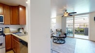 Located at 420 Activity Way in Oceanside, California, this single-floor residence offers a thoughtfully designed layout filled with natural light and a relaxed coastal ambiance. The living area serves as the heart of the home, featuring light wood-style flooring, a ceiling fan, and large sliding glass doors that open to a private balcony — ideal for enjoying the Southern California climate. Multiple windows allow abundant natural light to pour in, enhancing the open, airy feel of the space.

The kitchen is efficiently arranged with warm cherry wood cabinetry extending to the upper walls for generous storage, light countertops, stainless steel appliances including a range, microwave, refrigerator, and dishwasher, and light wood-style flooring that adds warmth throughout.

The bedroom is a calm retreat carpeted for comfort and outfitted with a ceiling fan, mirrored sliding closet doors, and windows dressed in sheer curtains that invite soft, natural light. The bathroom features wood-toned cabinetry, a light stone-finish countertop, and a tub-shower combination with clean, neutral finishes.

Ceiling fans throughout the residence ensure comfort year-round, and the private balcony extends the living space outdoors, completing this well-appointed Oceanside home.