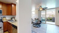 Located at 420 Activity Way in Oceanside, California, this single-floor residence offers a thoughtfully designed layout filled with natural light and a relaxed coastal ambiance. The living area serves as the heart of the home, featuring light wood-style flooring, a ceiling fan, and large sliding glass doors that open to a private balcony — ideal for enjoying the Southern California climate. Multiple windows allow abundant natural light to pour in, enhancing the open, airy feel of the space.

The kitchen is efficiently arranged with warm cherry wood cabinetry extending to the upper walls for generous storage, light countertops, stainless steel appliances including a range, microwave, refrigerator, and dishwasher, and light wood-style flooring that adds warmth throughout.

The bedroom is a calm retreat carpeted for comfort and outfitted with a ceiling fan, mirrored sliding closet doors, and windows dressed in sheer curtains that invite soft, natural light. The bathroom features wood-toned cabinetry, a light stone-finish countertop, and a tub-shower combination with clean, neutral finishes.

Ceiling fans throughout the residence ensure comfort year-round, and the private balcony extends the living space outdoors, completing this well-appointed Oceanside home.