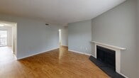 Located at 5201 Western Ave in Knoxville, Tennessee, this single-floor home offers four bedrooms and two full bathrooms across a well-organized layout. The living room serves as a welcoming central gathering space, featuring warm hardwood-style flooring, a classic fireplace with a tiled hearth and white mantle, and windows that allow natural light to fill the room. A closet with louvered doors adds convenient storage directly off the living area.

The galley-style kitchen is efficiently designed with dark cabinetry, granite-look countertops, a stainless steel sink, and black appliances including an electric range and built-in microwave. The hardwood-style flooring continues throughout the kitchen, which connects seamlessly to the rest of the home via a central hallway.

The four bedrooms are carpeted and bright, each offering a comfortable and private retreat. The generously sized primary bedroom includes a dedicated closet, while additional bedrooms feature windows with natural light and easy access to shared spaces. Two closets throughout the home provide ample storage.

Both bathrooms are clean and functional, each equipped with a full tub-shower combination, toilet, and a vanity with a granite-look countertop and dark cabinetry. Textured ceilings are consistent throughout the home, contributing to its classic residential character.