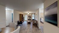 Located at 5250 Highway 138 in Union City, Georgia, this single-floor residence offers a well-designed layout that balances comfort and functionality. The open-concept living area is anchored by durable wood-style flooring and filled with natural light from large windows and a glass-paneled door that leads to the exterior, creating a bright and welcoming atmosphere. A ceiling fan with a glass light fixture adds a classic touch overhead.

The kitchen is well-appointed with ample white cabinetry, generous counter space featuring speckled laminate countertops, and black appliances including a full-size refrigerator, electric range with overhead ventilation, and dishwasher. It opens conveniently to a dedicated dining area, making the space ideal for everyday living and entertaining.

The bedrooms are spacious and carpeted, offering a soft contrast to the hard flooring found throughout the rest of the home. The primary bedroom includes access to a private full bathroom and features multiple windows that invite natural light and outdoor views. Additional bedrooms are well-sized with ample closet space.

Both bathrooms are finished with clean white tilework, tub/shower combinations, and wood-style flooring, providing a consistent and cohesive aesthetic. The overall design of this residence is neutral and inviting, offering a functional and comfortable living environment.